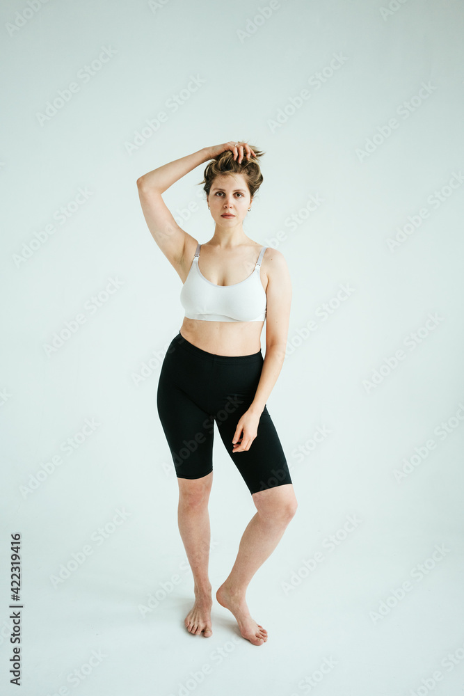Natural pretty curvy model woman wearing underwear in white photo studio Natural pretty curvy model woman wearing underwear in white photo studio