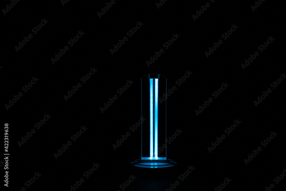 Modern ultraviolet lamp glowing on black background Modern ultraviolet lamp glowing on black background