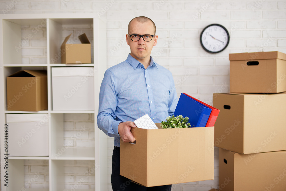 happy man with boxes moving to new office. happy man with boxes moving to new office.