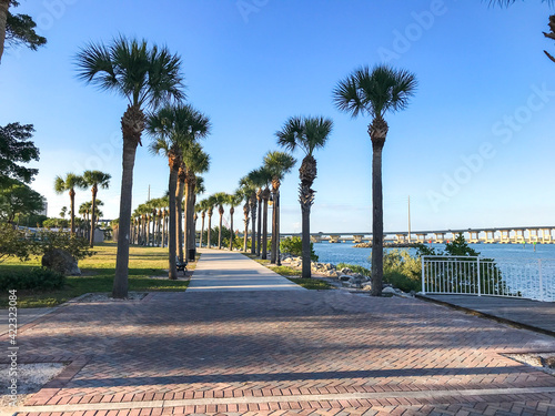 Fort Pierce, St. Lucie County, Florida, Waterfront walkway lined with palm trees along Indian River Drive. Sunny day, bridge in the background. Near downtown Fort Pierce.