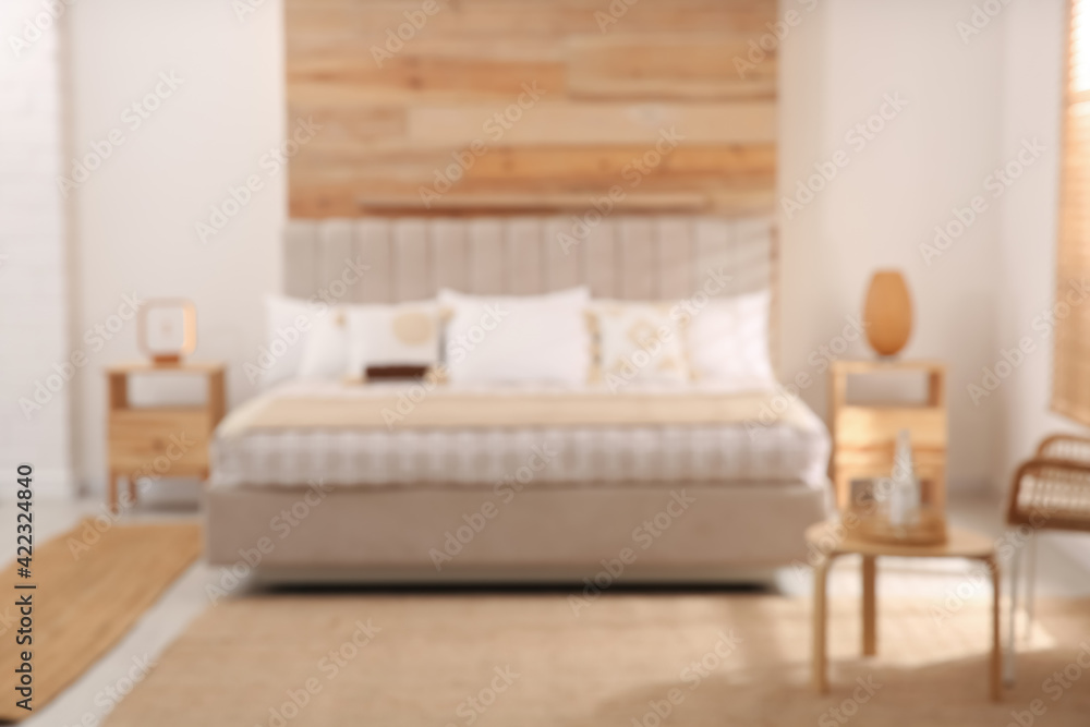 Blurred view of stylish hotel room interior with comfortable bed Blurred view of stylish hotel room interior with comfortable bed