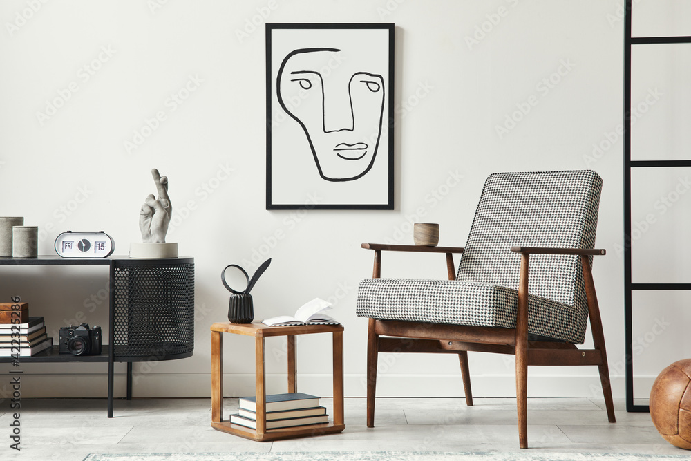 Fototapeta premium Stylish scandinavian composition of living room with design armchair, black mock up poster frame, commode, wooden stool, plant, decoration, loft wall and personal accessories in modern home decor.