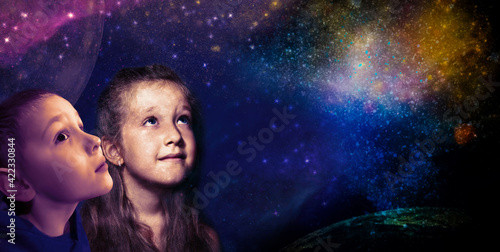 Childhood and dream concept. Conceptual image with girl and boy dreaming about space, stars, planets.