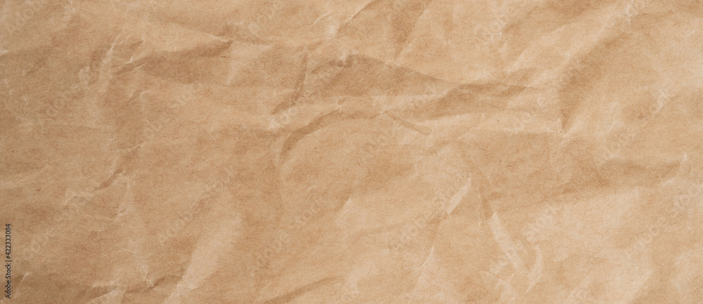 Close up crumpled brown paper texture and background with copy space Close up crumpled brown paper texture and background with copy space
