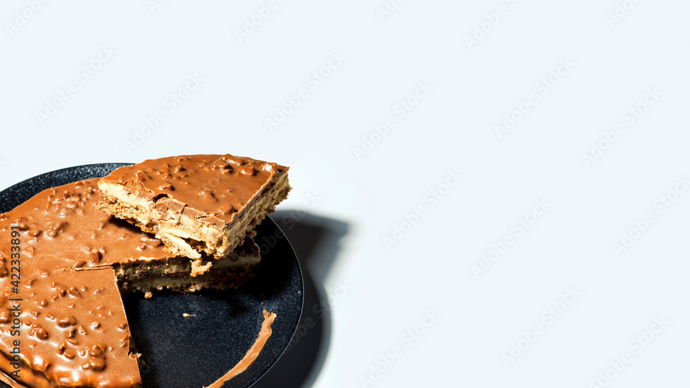 Swedish almond and chocolate cake with a slice cut off, with filling and nuts