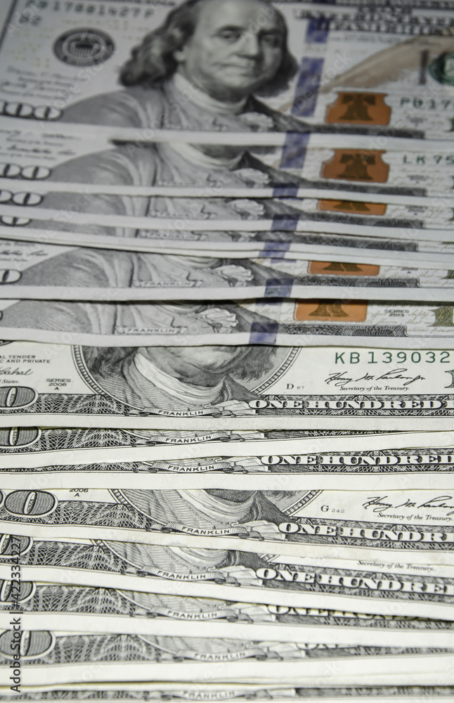Old and new one hundred dollar bills are on table. US dollars background. American currency. Cash money for payment. World financial system concept. Old and new one hundred dollar bills are on table. US dollars background. American currency. Cash money for payment. World financial system concept.