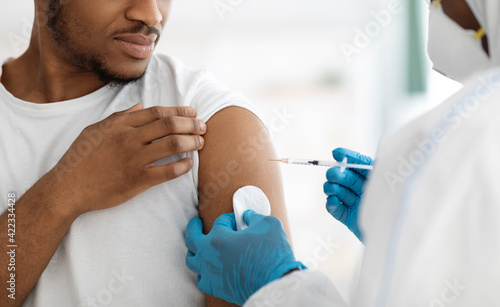 Cropped of black man receiving vaccine shot photo