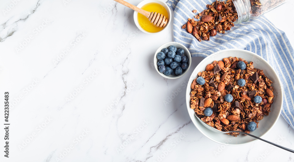 Homemade granola, muesli with pieces of dark chocolate, nuts and blueberries Homemade granola, muesli with pieces of dark chocolate, nuts and blueberries