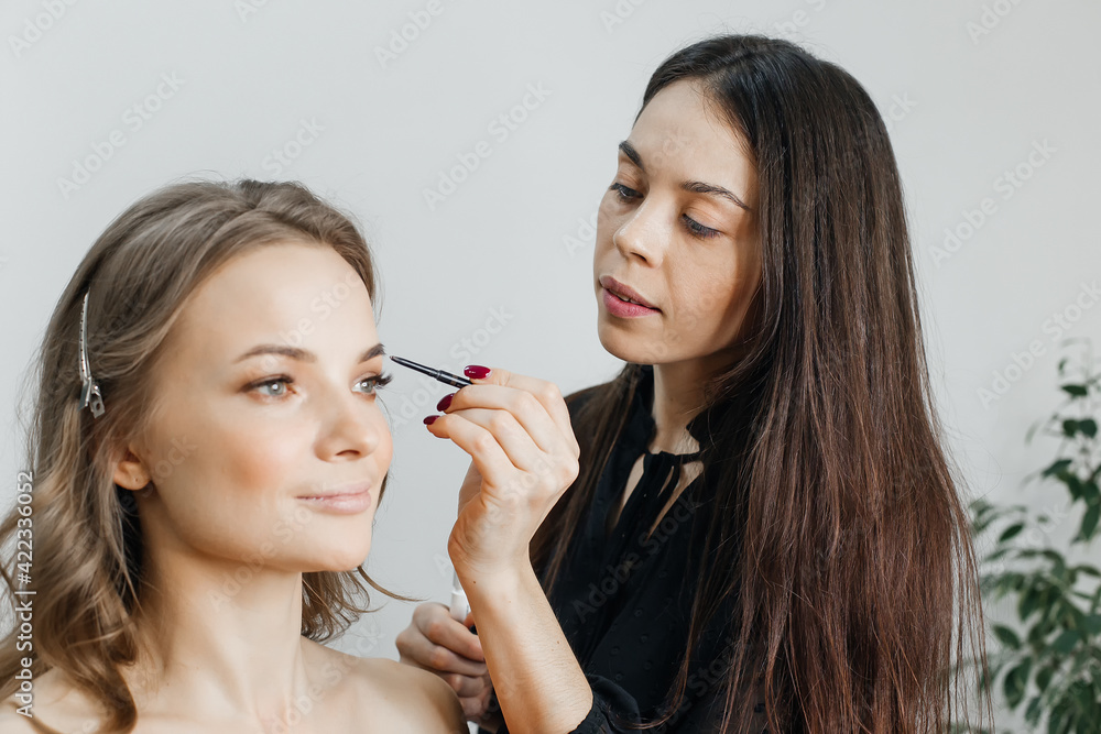 master does a beautiful blonde makeup in a beauty salon master does a beautiful blonde makeup in a beauty salon