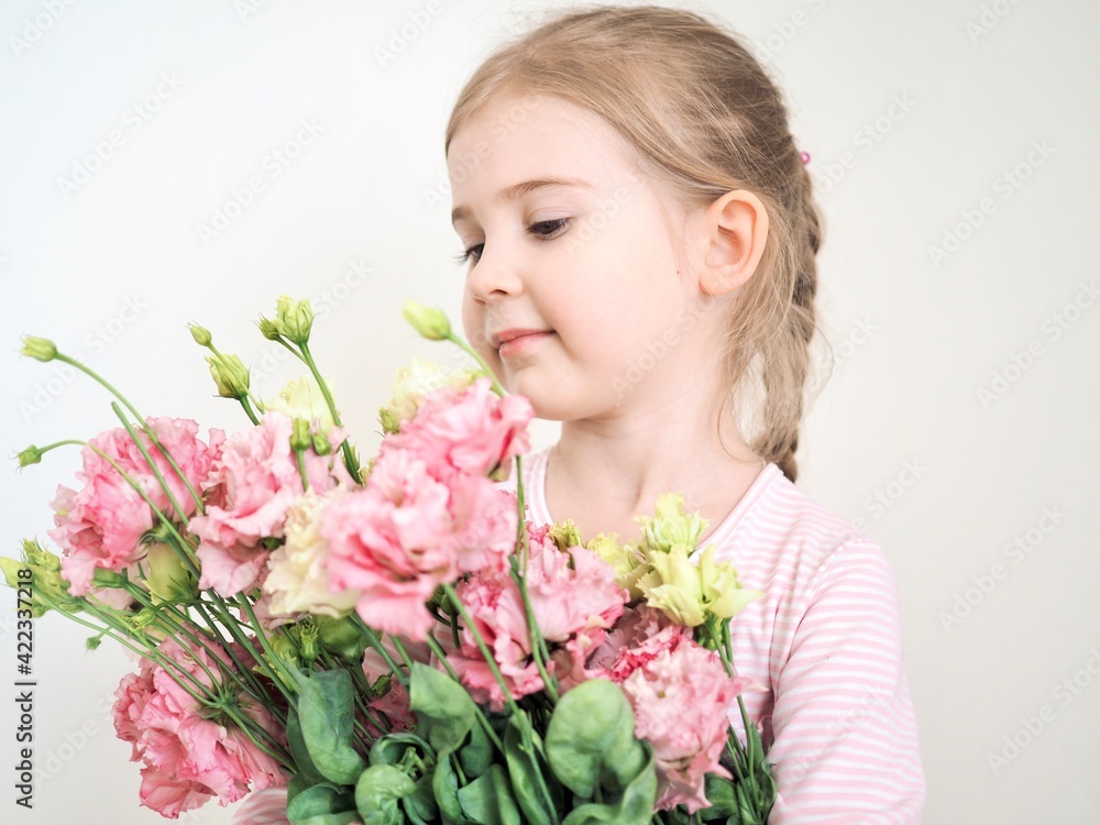 Adorable little girl holding bouquet of flowers. Cute happy child with flower bouquet. Happy Easter. Hello spring banner Adorable little girl holding bouquet of flowers. Cute happy child with flower bouquet. Happy Easter. Hello spring banner