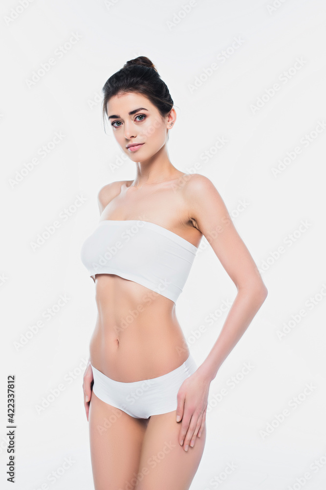 Obraz premium Pretty woman in underwear looking at camera isolated on white