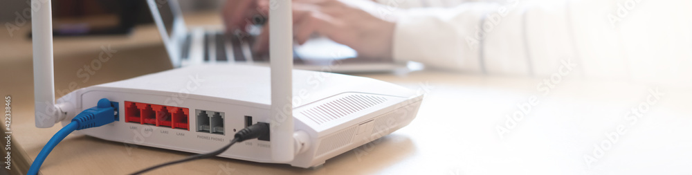ฺฺBanner horizontal shot of Internet router on working table with ...