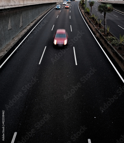 Wallpaper Mural A red car in movement on a black asplalt road, light trails and intentional movement/zoom effect. Torontodigital.ca