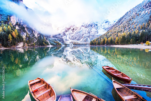 Magical beautiful fairy autumn landscape with boats on the lake on Fanes-Sennes-Braies natural park in the Dolomites in South Tyrol, Alps, Italy, Europe. Exotic amazing places. (harmony - concept)