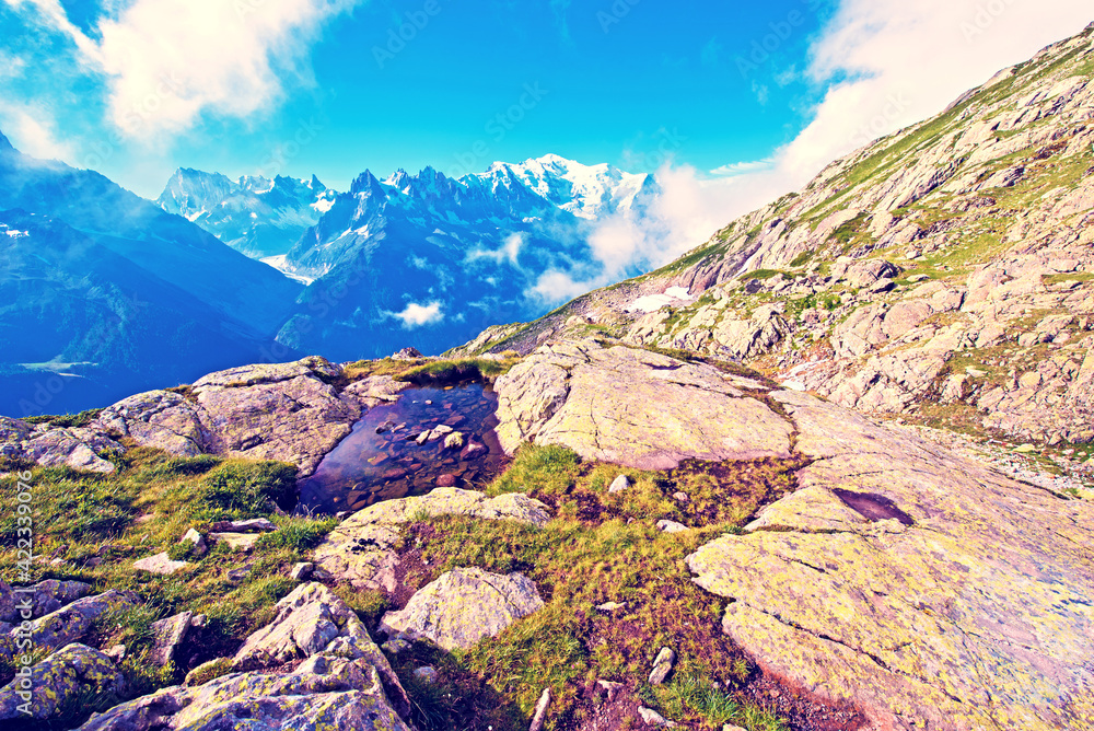 Beautiful mountain landscape with stones in water in French Alps, massif La Blanc. (Harmony, tourism, meditation - concept)