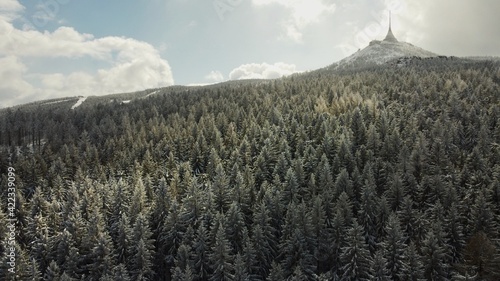 Winter drone photo of Ještěd. Snow covered trees.