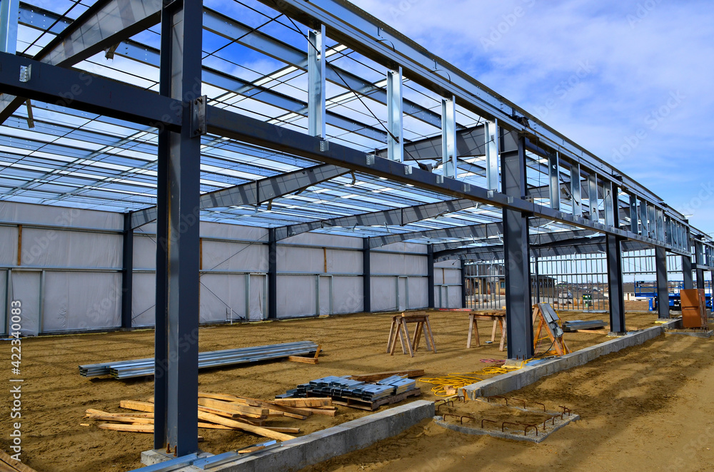 Steel frame commercial building under construction for expanding local business in urban area.