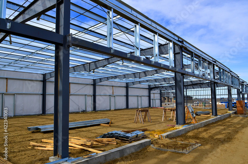 Steel frame commercial building under construction for expanding local business in urban area.