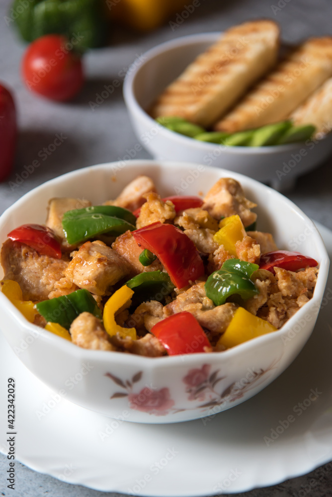 Popular delicacy minced chicken pieces and bell peppers in a bowl with use of selective focus. Popular delicacy minced chicken pieces and bell peppers in a bowl with use of selective focus.
