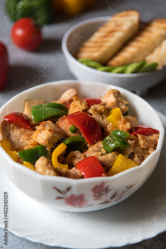 Popular delicacy minced chicken pieces and bell peppers in a bowl with use of selective focus.