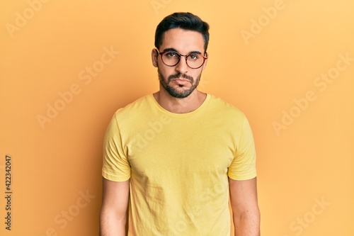 Young hispanic man wearing casual clothes and glasses depressed and worry for distress, crying angry and afraid. sad expression.