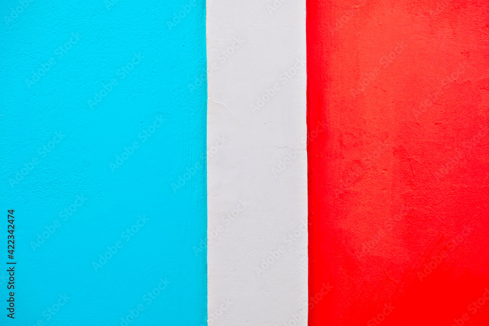 Surface painted bright red and blue, with a white stripe between the contrasting areas.