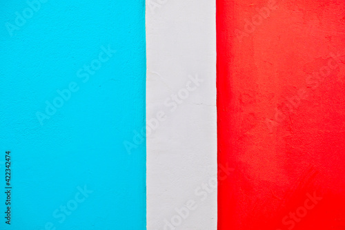 Surface painted bright red and blue, with a white stripe between the contrasting areas.