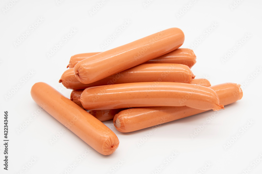 Fresh sausages lie in a pile on a white background. Fresh sausages lie in a pile on a white background.