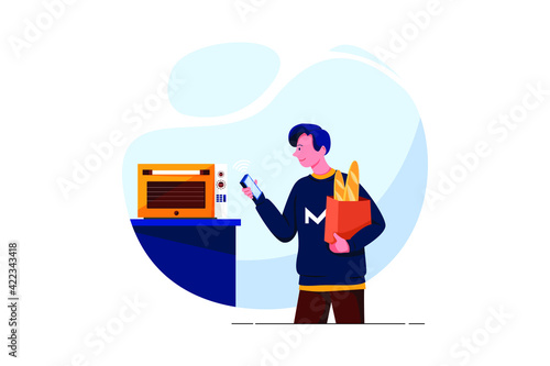 Happy young man looking at oven with voice recognition function in kitchen