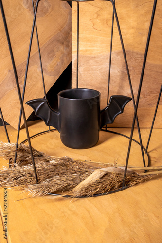 black batman style mug on wooden table photo