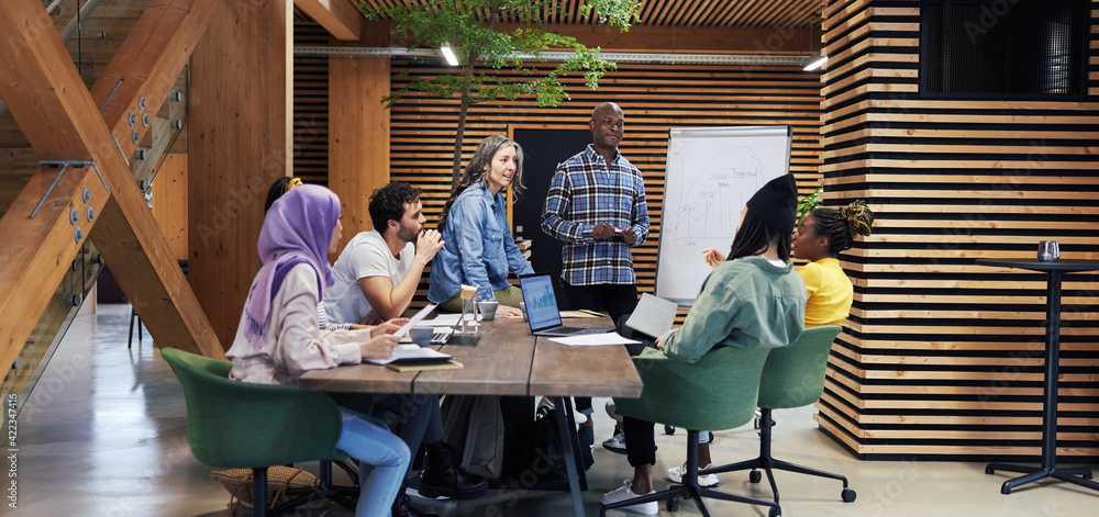 Diverse businesspeople discussing work in a meeting Diverse businesspeople discussing work in a meeting
