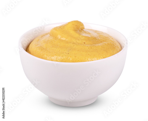 Mustard in white bowl isolated on white background