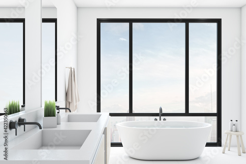Modern comfortable bathroom with a panoramic window, city view, mirror and a sink.