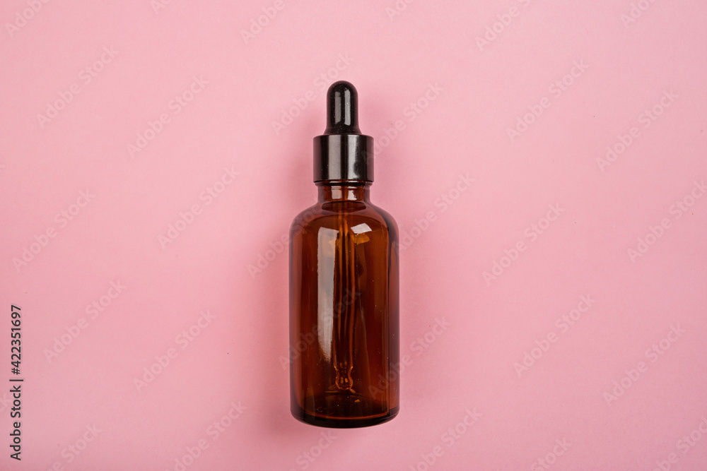 Flat lay with Natural organic cosmetics: serum on pink background. Skincare, cosmetology, dermatology concept. Beauty certificate, blog style. Top view, mockup, overhead