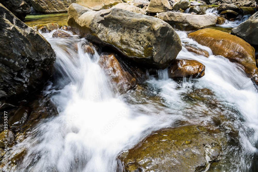 The stones under the waterfall, close-up waterfall as background. The stones under the waterfall, close-up waterfall as background.