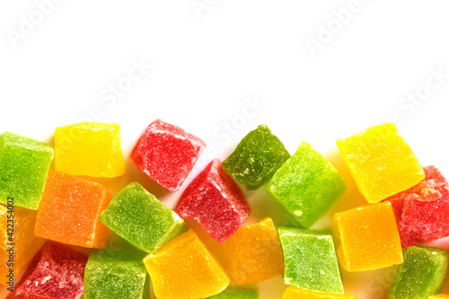 Multicolored cubes of sweet candied fruits isolated on white. Blank for the designer.