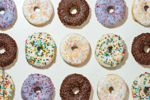 Doughnuts set. Top view of delicious assorted round glazed donuts with colorful sprinkles