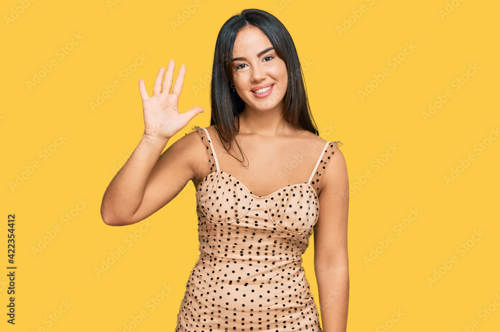 Young beautiful hispanic girl wearing sexy party dress showing and pointing up with fingers number five while smiling confident and happy. Young beautiful hispanic girl wearing sexy party dress showing and pointing up with fingers number five while smiling confident and happy.