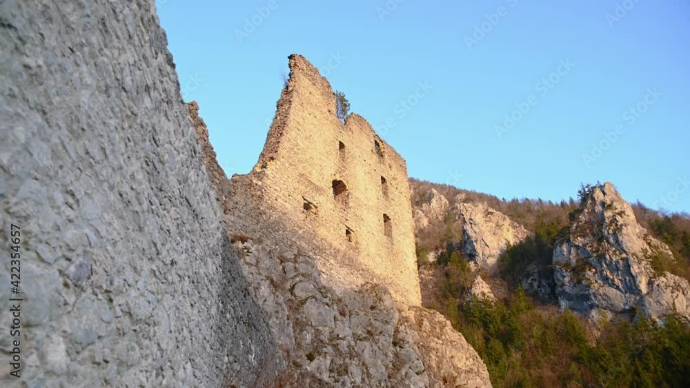 Walking under medieval castle Kamen in Slovenia decayed and collapsed defense thick walls and watchtower. Middle age fortress located in Alpine valley. Forward moving, wide angle Walking under medieval castle Kamen in Slovenia decayed and collapsed defense thick walls and watchtower. Middle age fortress located in Alpine valley. Forward moving, wide angle