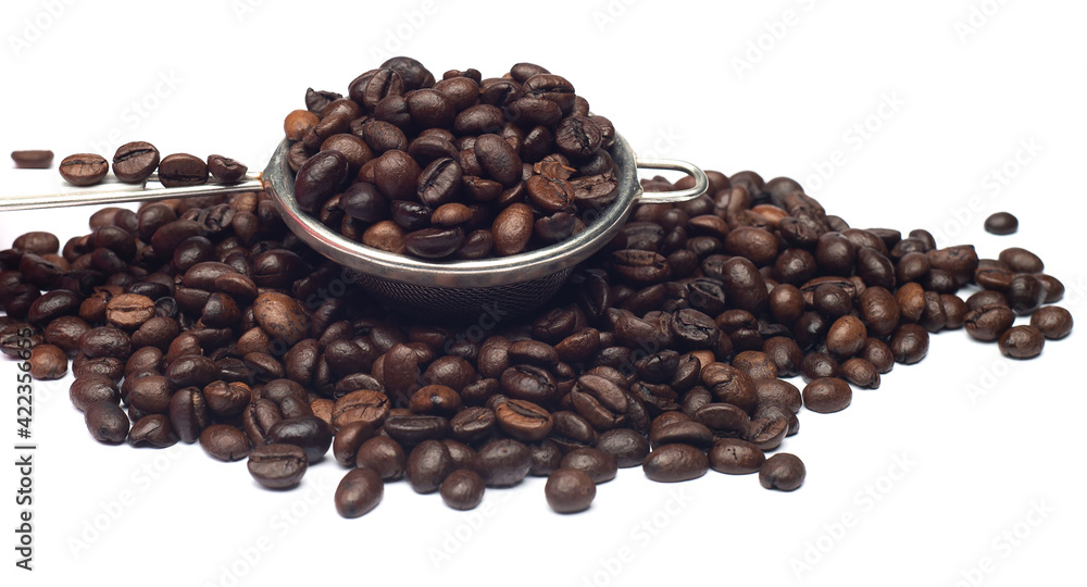 Fototapeta premium dark roasted coffee beans on a white background