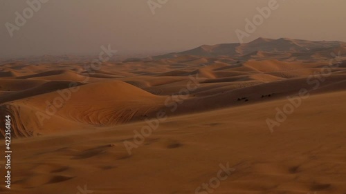 Landscape of desert dunes at sunset on a windy day