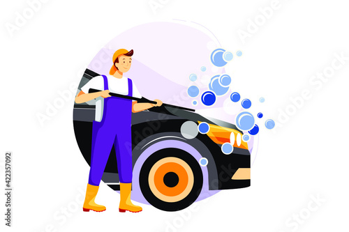 Mechanic washing the car with high pressure water