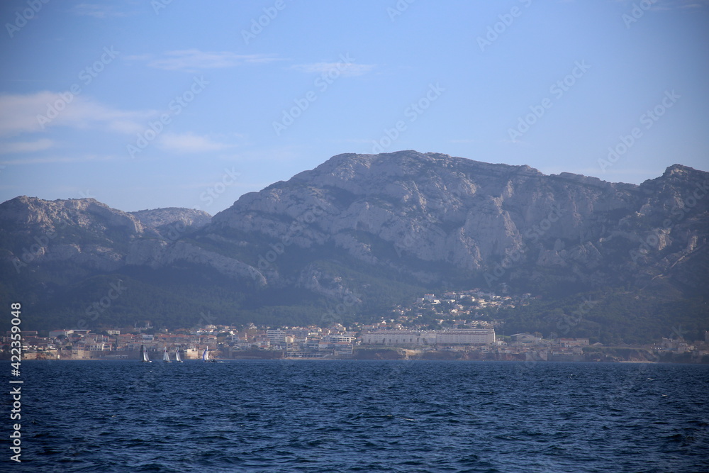 Sailboats with the city on the coast in the background, Parc National des Calanques, Marseille, France