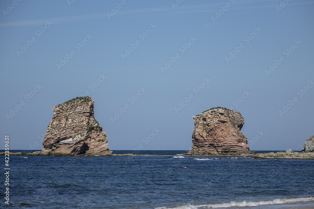 Fototapeta premium 3 km long, the longest beach in the Basque Country is in Hendaye. Two-twins (Les Deux-Jumeaux) at Cape Sainte-Anne on the background. Hendaye, Basque Country coast, Pyrenees Atlantiques, France,
