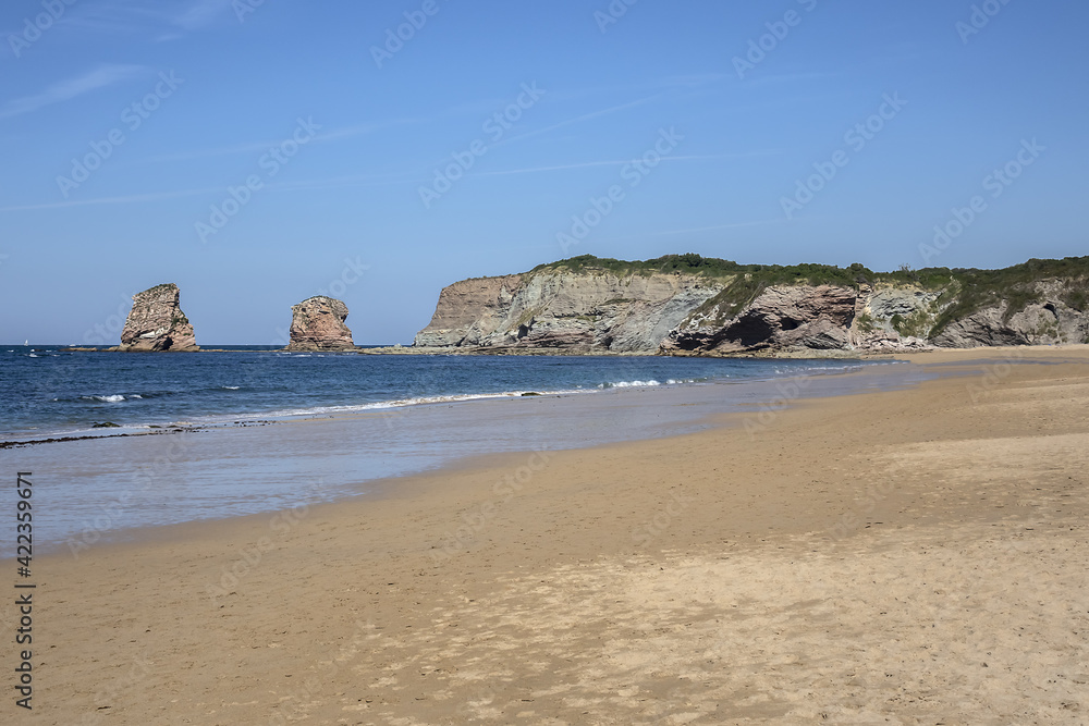 3 km long, the longest beach in the Basque Country is in Hendaye. Two-twins (Les Deux-Jumeaux) at Cape Sainte-Anne on the background. Hendaye, Basque Country coast, Pyrenees Atlantiques, France,