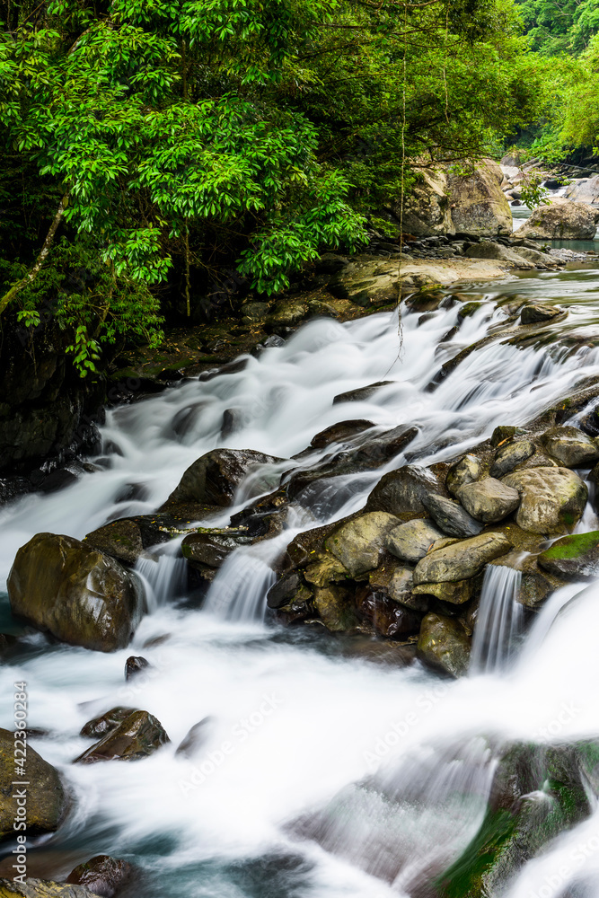 Creek or stream water flowing past rocks and stones Creek or stream water flowing past rocks and stones