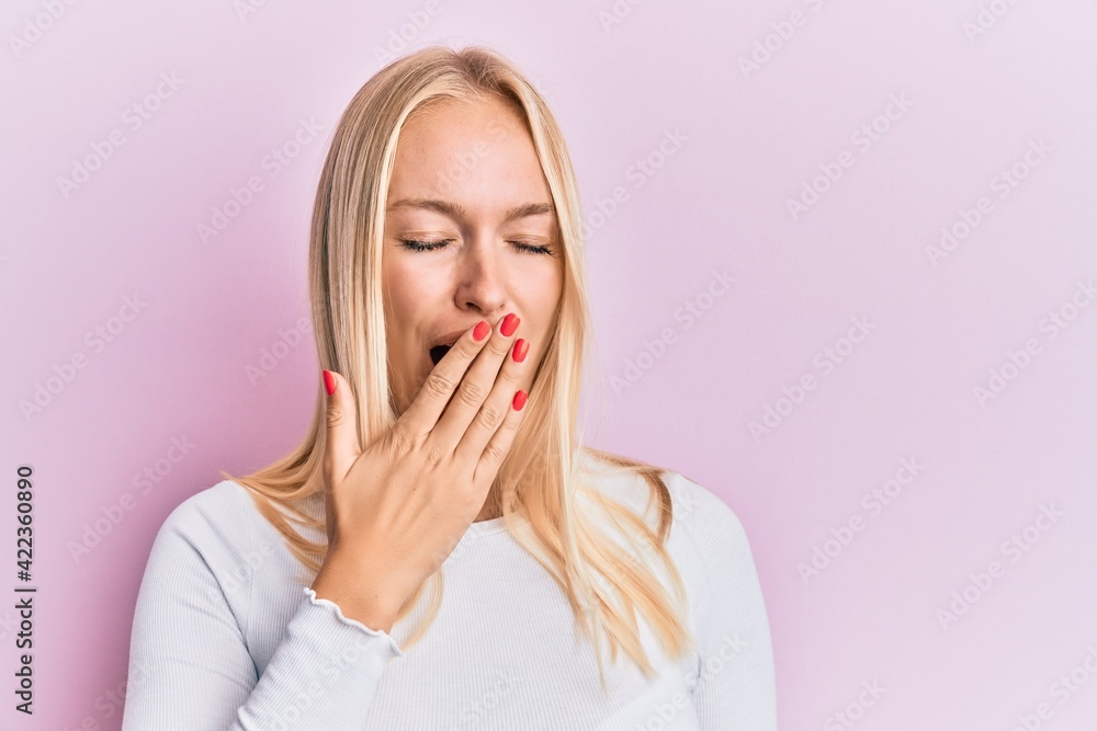 Young blonde girl wearing casual clothes bored yawning tired covering mouth with hand. restless and sleepiness. Young blonde girl wearing casual clothes bored yawning tired covering mouth with hand. restless and sleepiness.