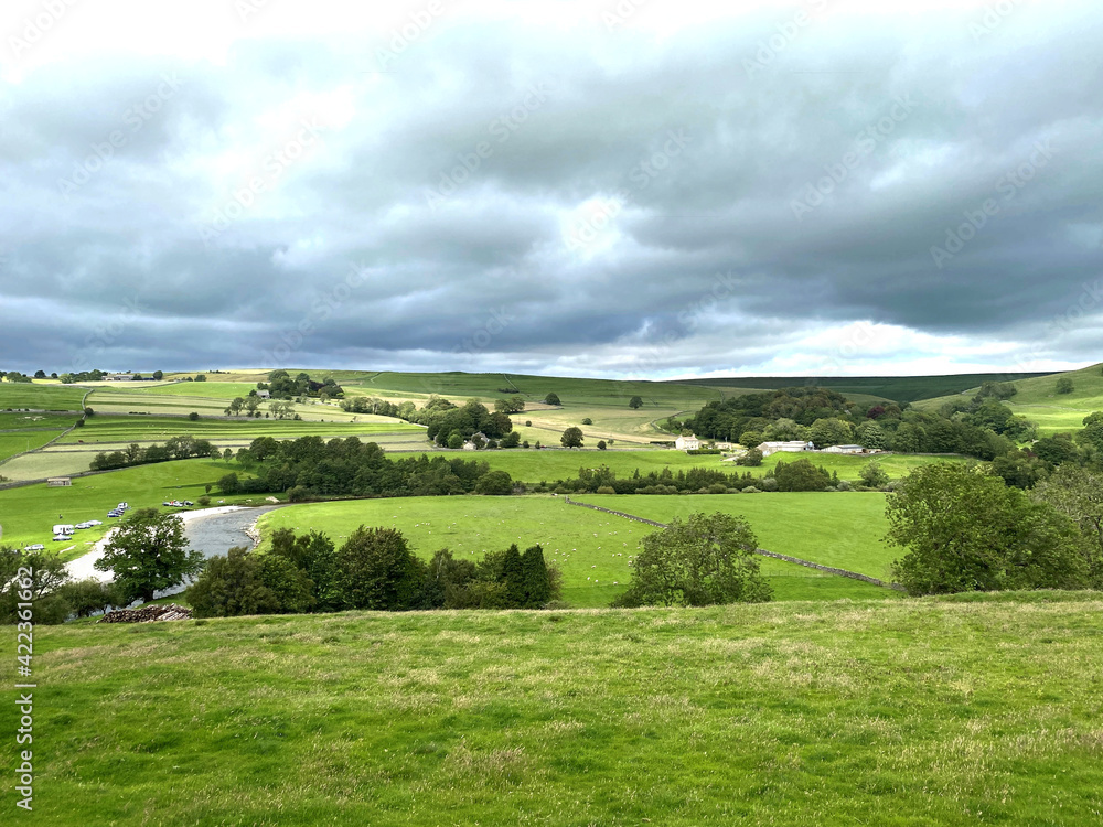Landscape view, over the, fields, meadows, and the River Wharfe near, Burnsall, Skipton, UK