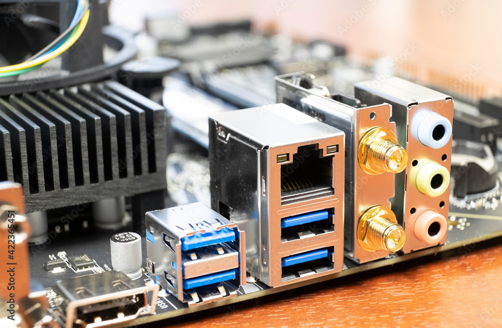 Close up of a desktop computer motherboard. LAN connectors, USB, audio ports Close up of a desktop computer motherboard. LAN connectors, USB, audio ports