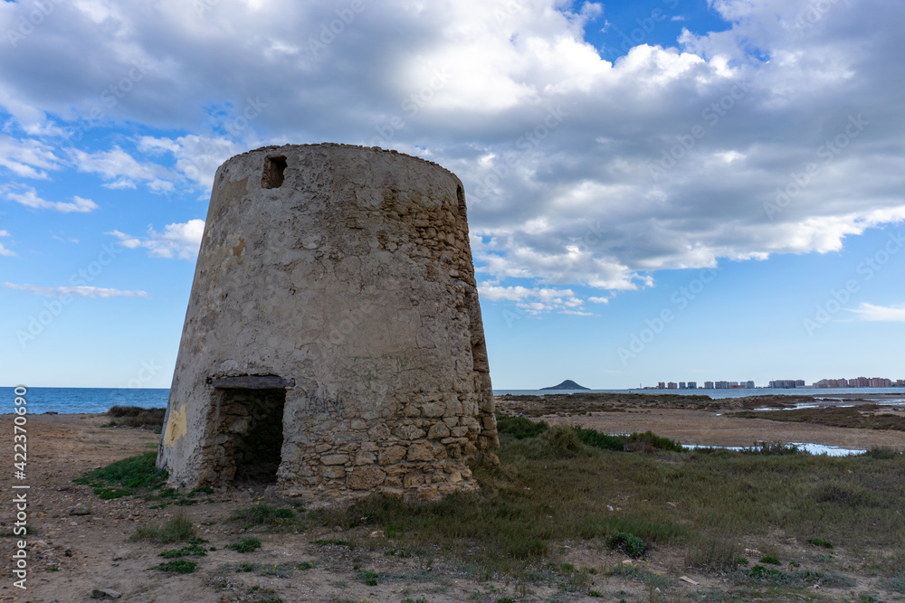 view of old windmill ruins on the coast of Murcia at sunset